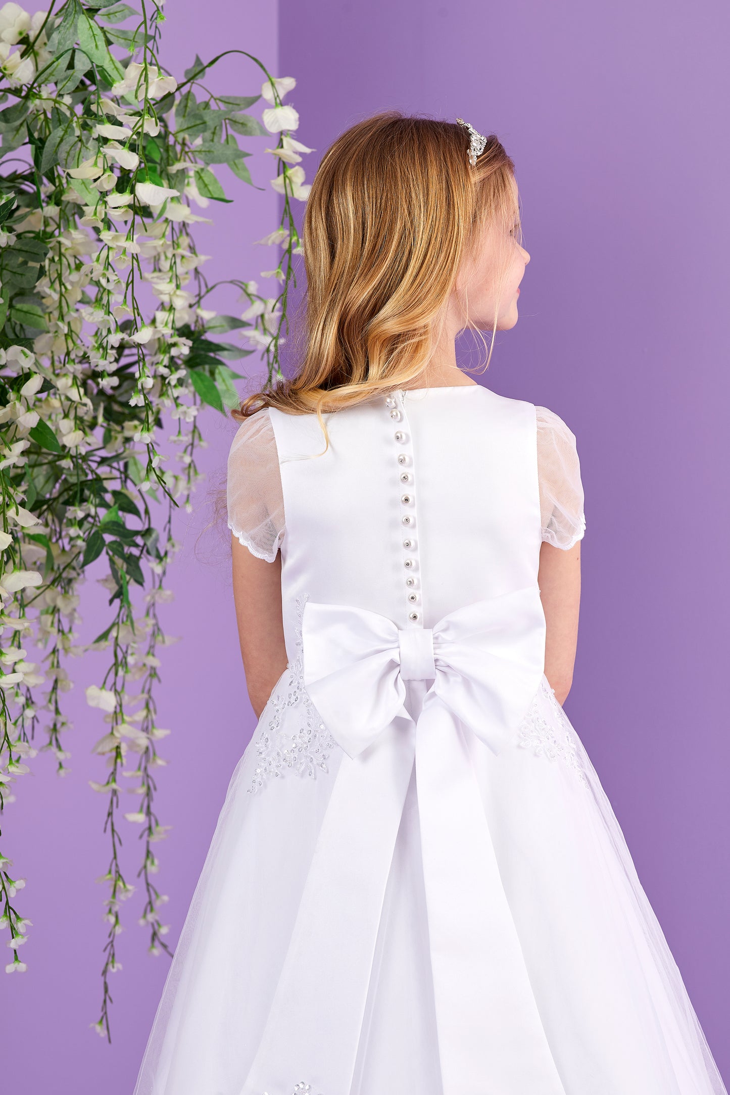 Sabrina White Holy Communion Dress featuring Embellished Motifs and Lace Edged Hem Available October 2026
