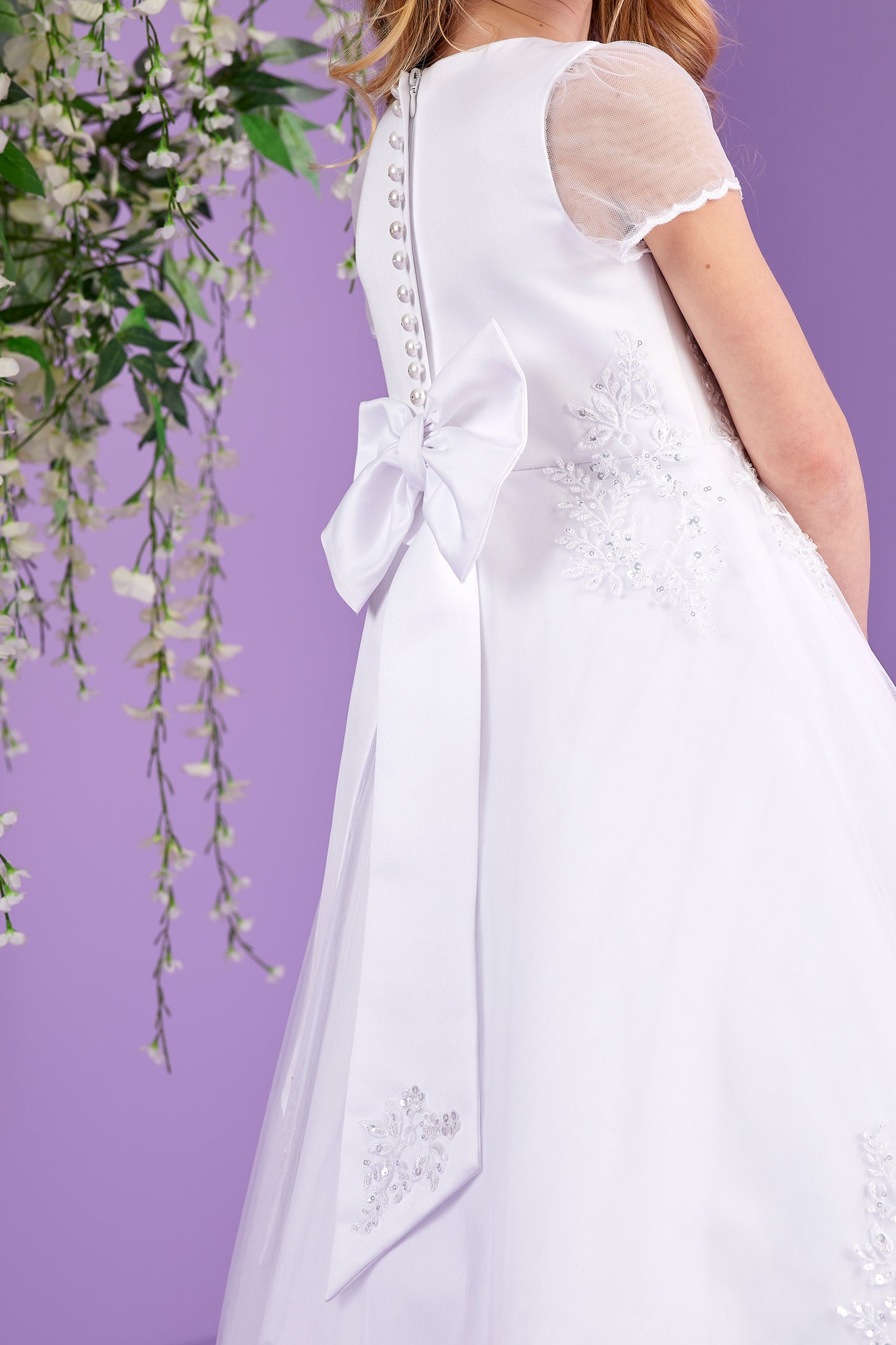 Sabrina White Holy Communion Dress featuring Embellished Motifs and Lace Edged Hem Available October 2026