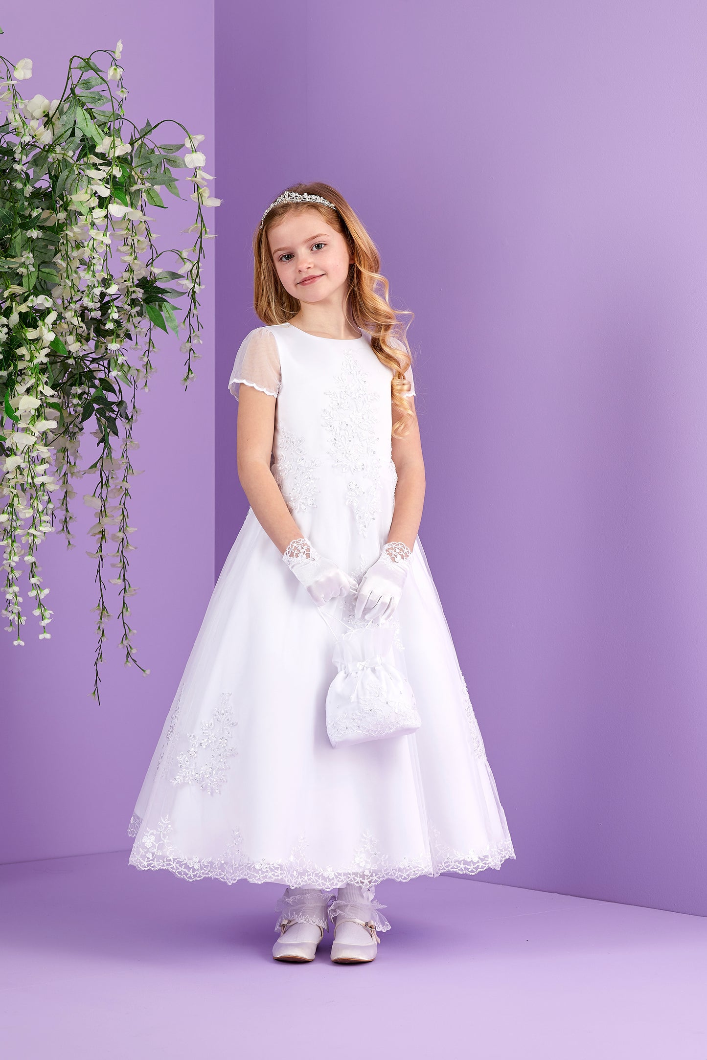 Sabrina White Holy Communion Dress featuring Embellished Motifs and Lace Edged Hem Available October 2026